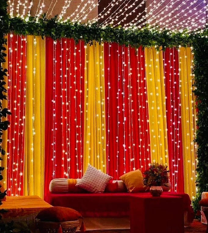 imgi_6_Elegant_Wedding_Backdrop_with_Red_Yellow_Drapes_and_String_Lights